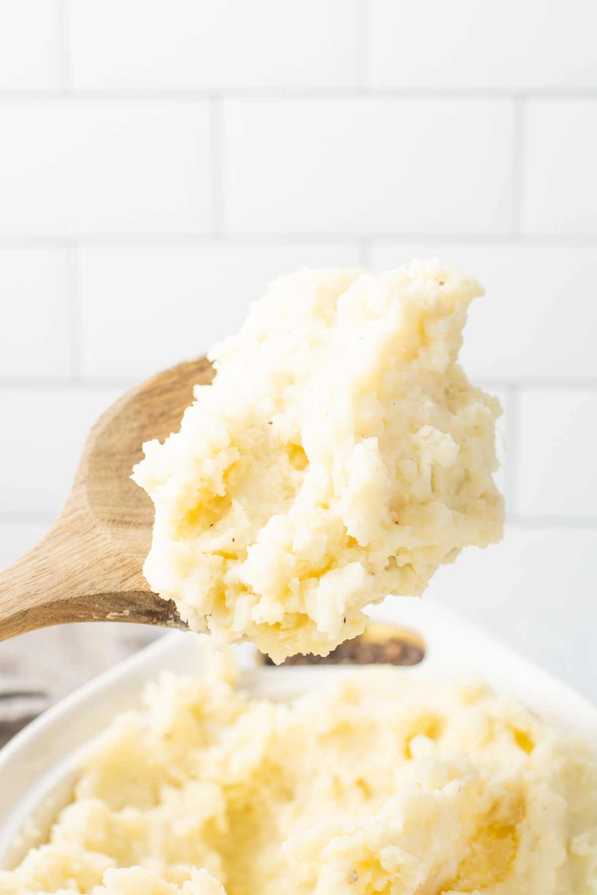 a wooden spoon of mashed potatoes
