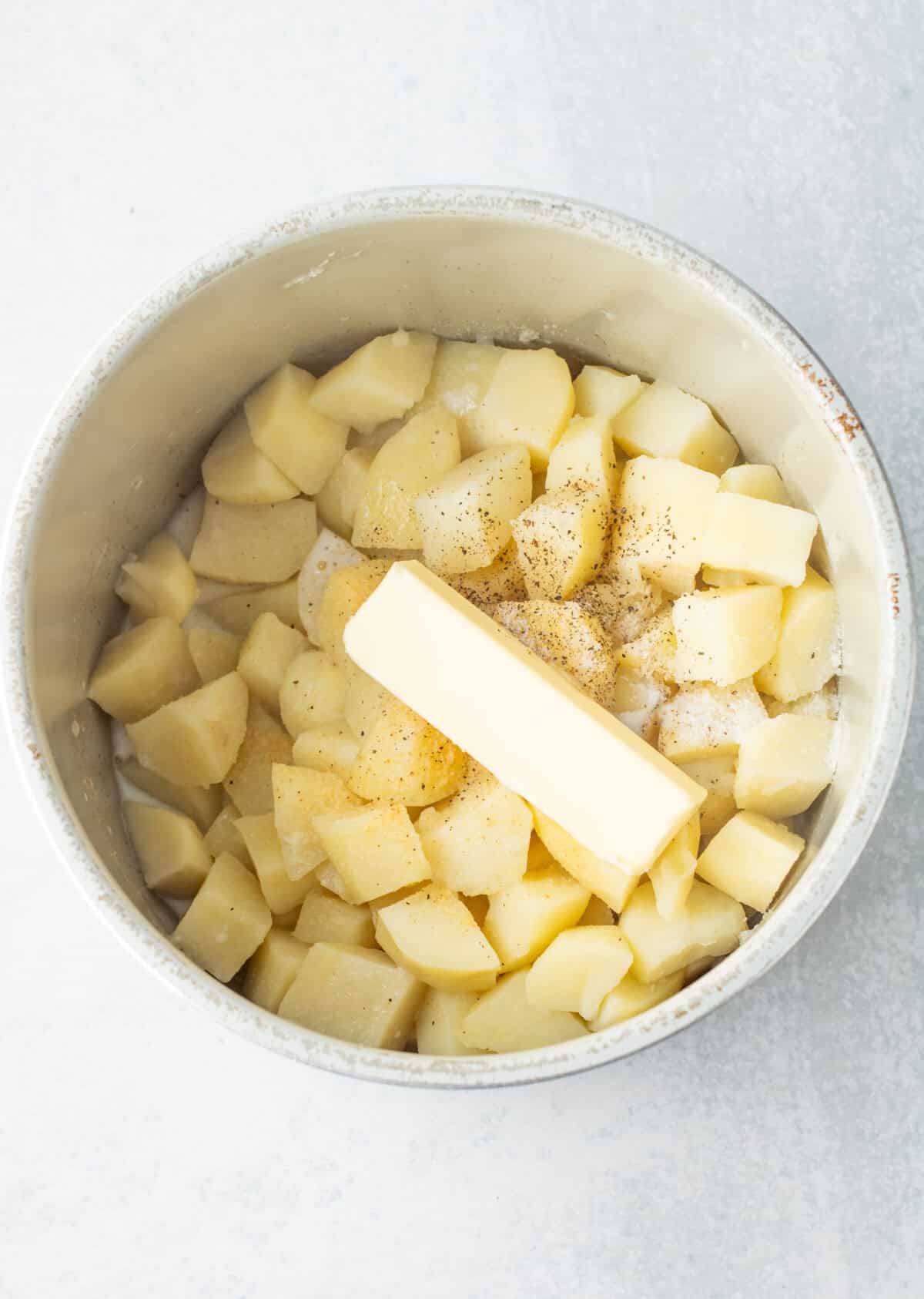stick of butter added to cooked potatoes