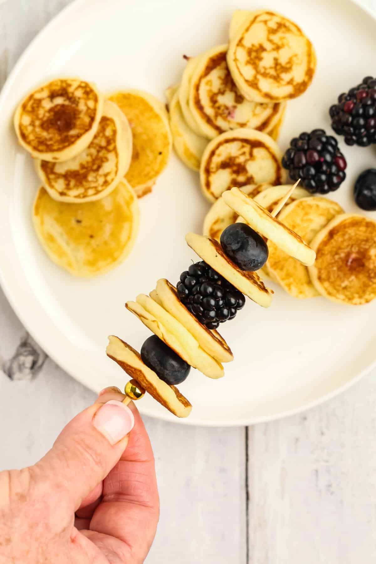 skewer of mini pancakes with blackberries and blueberries