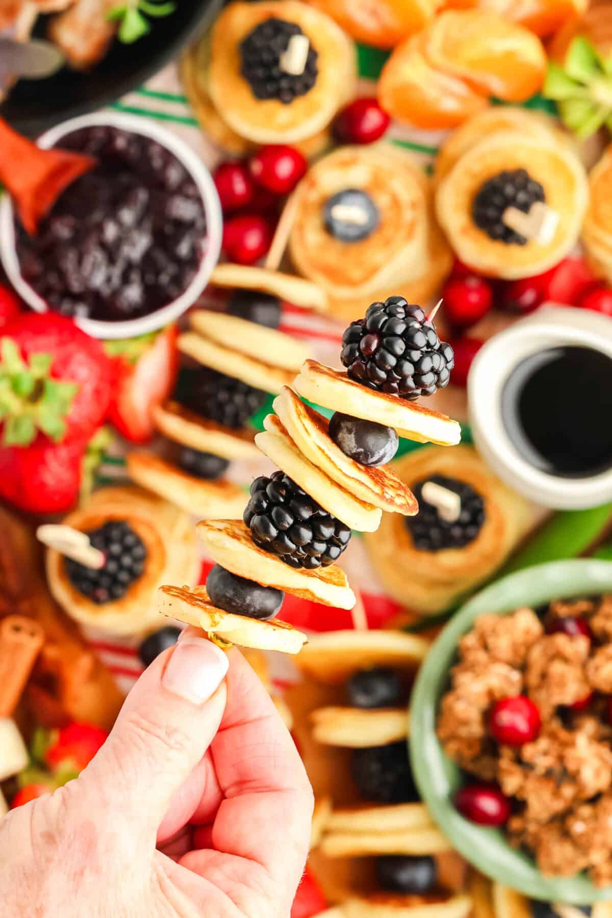 mini pancakes on a skewer with blackberries