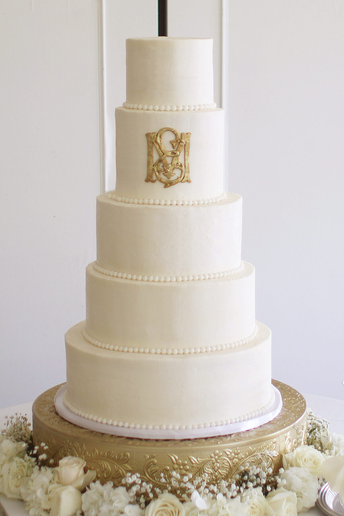 wedding cake with gold monogram
