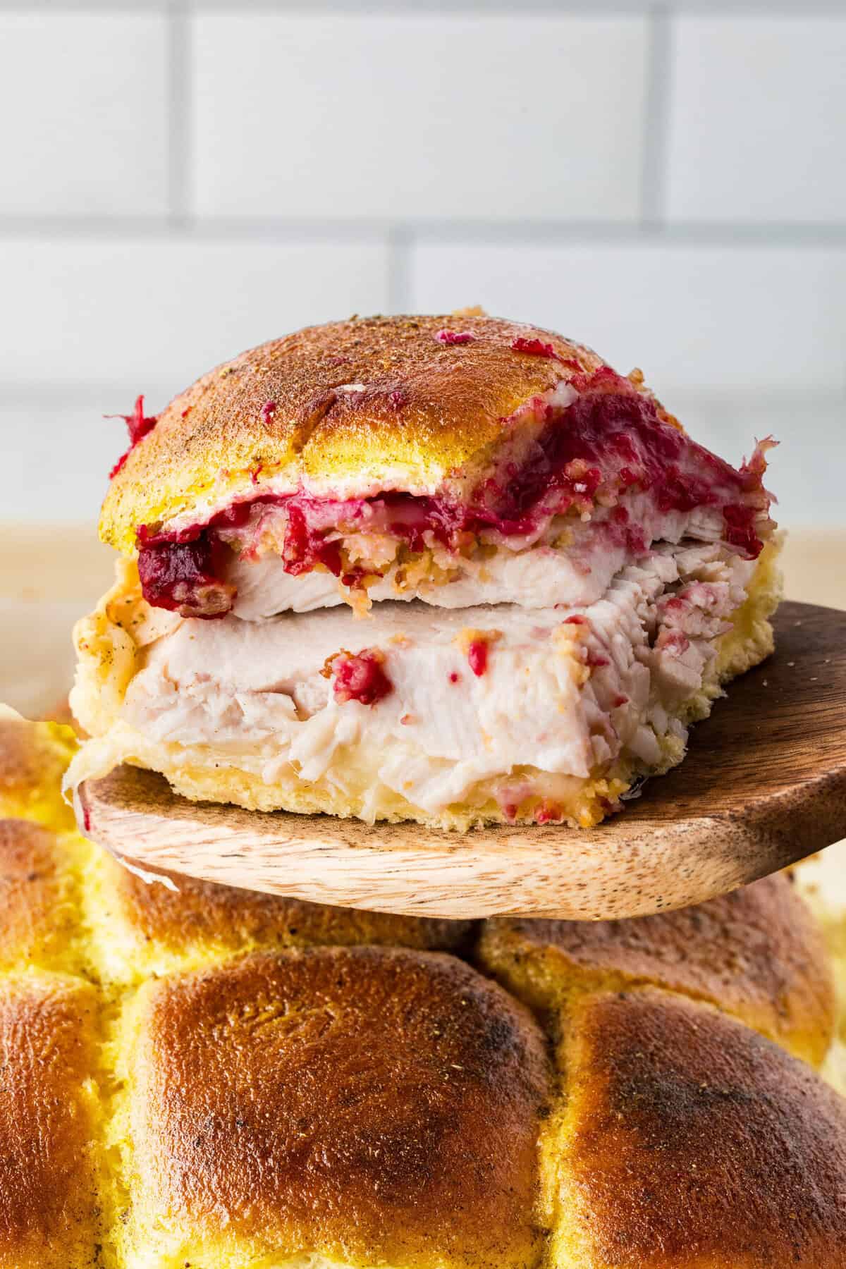 turkey sliders being lifted out of dish