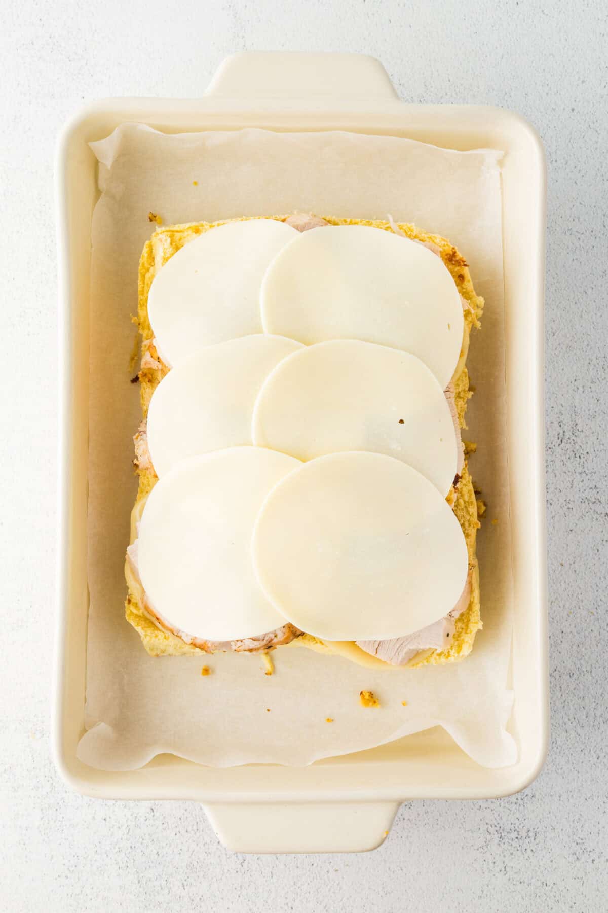 cheese placed over turkey and dressing on rolls