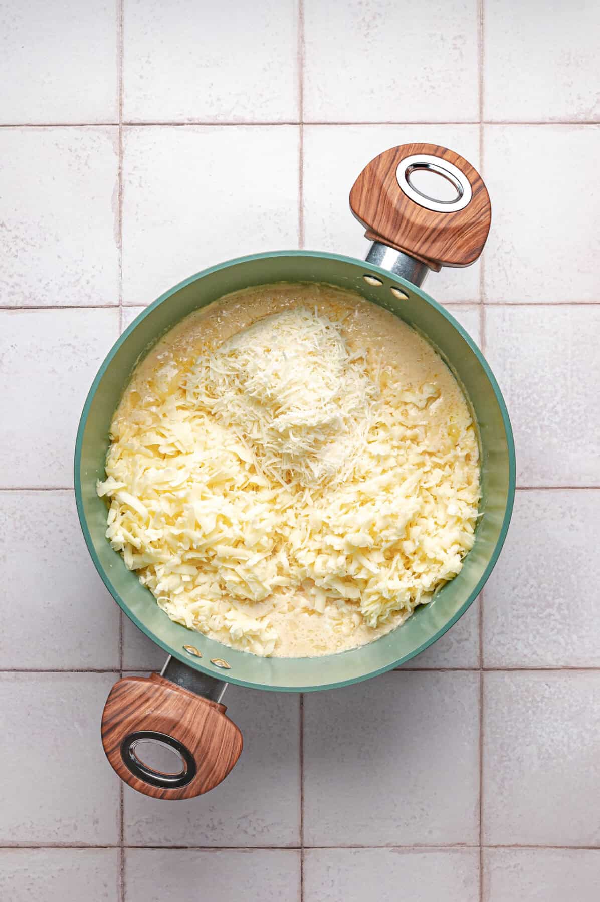 shredded cheeses added to sauce